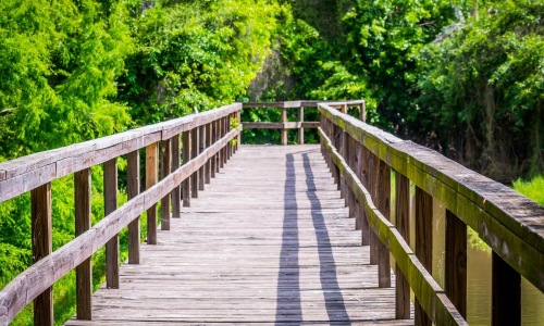 a wooden bridge with railings