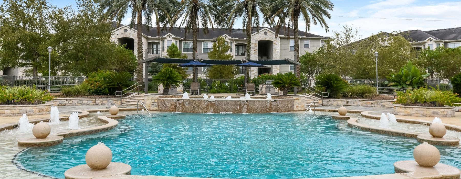 a large building with a pool in front of it