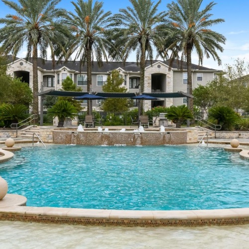 a large building with a pool in front of it