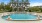 a large building with a pool in front of it