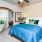 a bedroom with a bed and a fan